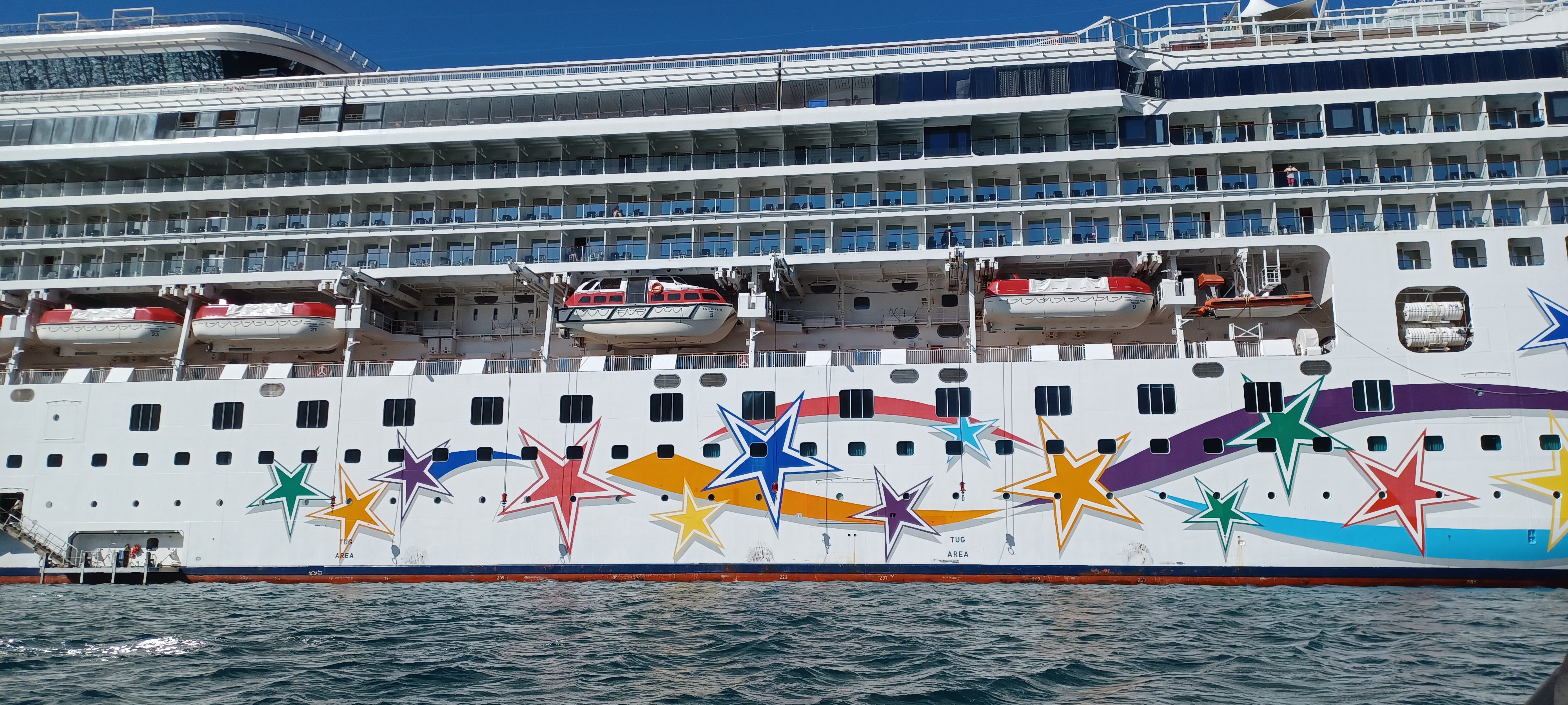 a large cruise ship with colorful stars on the side