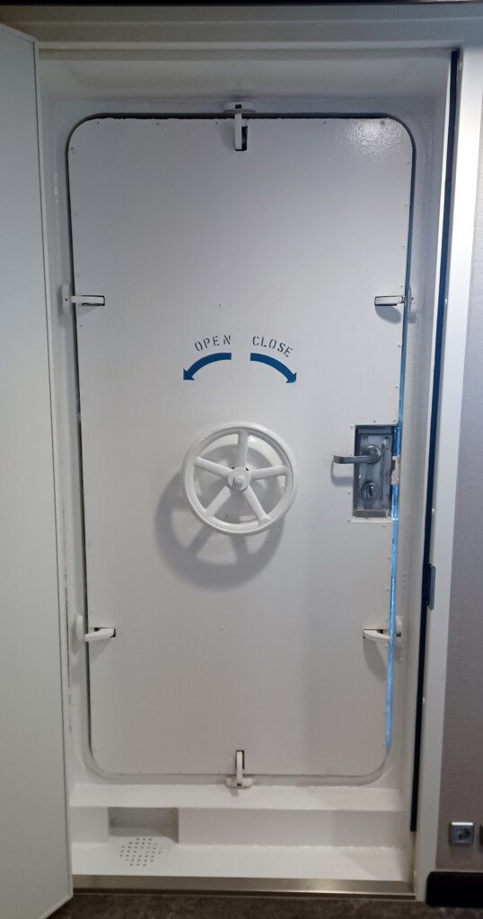 a white door with a wheel on it