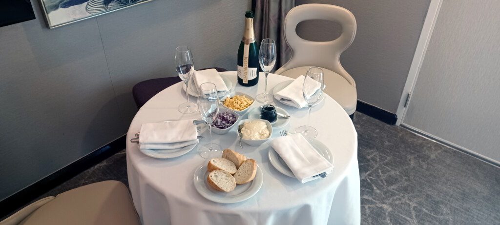 a table with food and wine glasses
