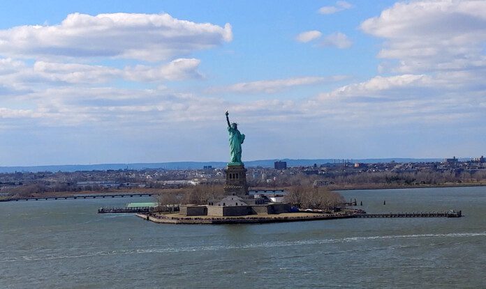 a statue of liberty on an island in the middle of a body of water