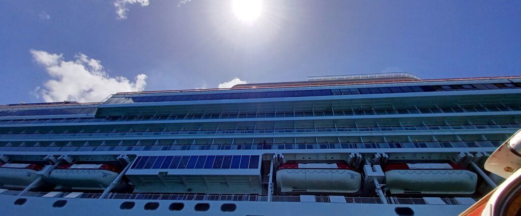 a large cruise ship with a life boat on the deck