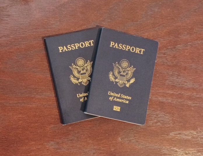 two blue passports on a wooden surface