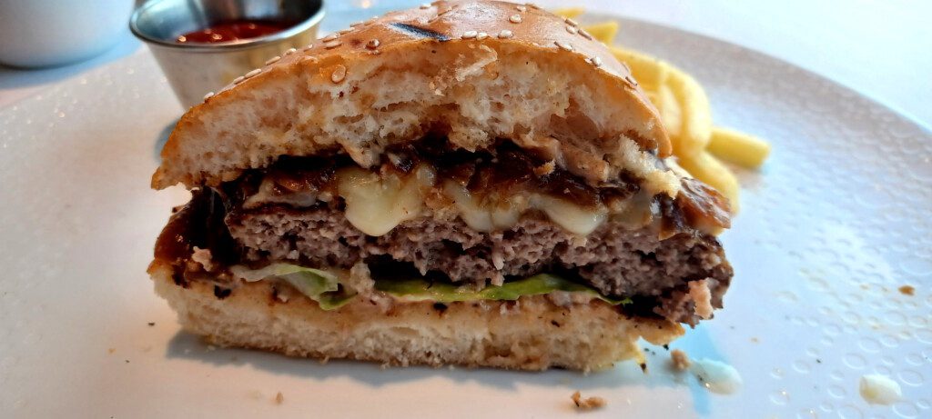 a burger with cheese and lettuce on a plate