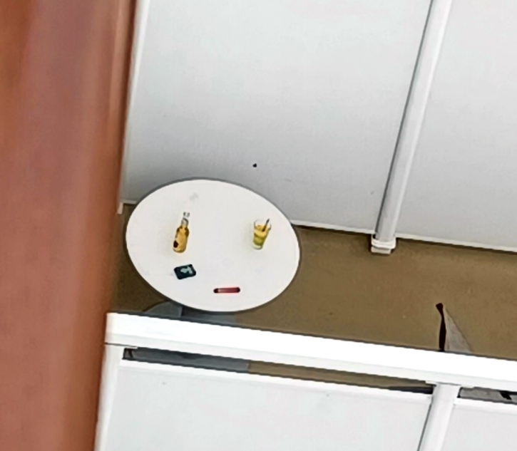 a small white table with a couple bottles on it
