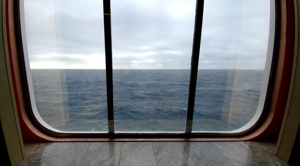 a room with a window overlooking the ocean
