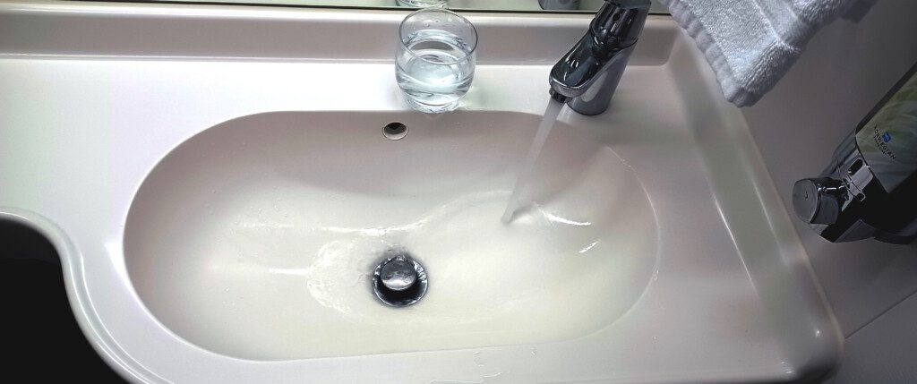 a water running from a faucet into a sink