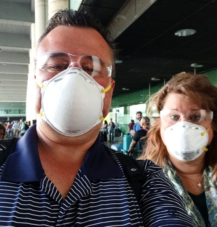 a man and woman wearing face masks and goggles