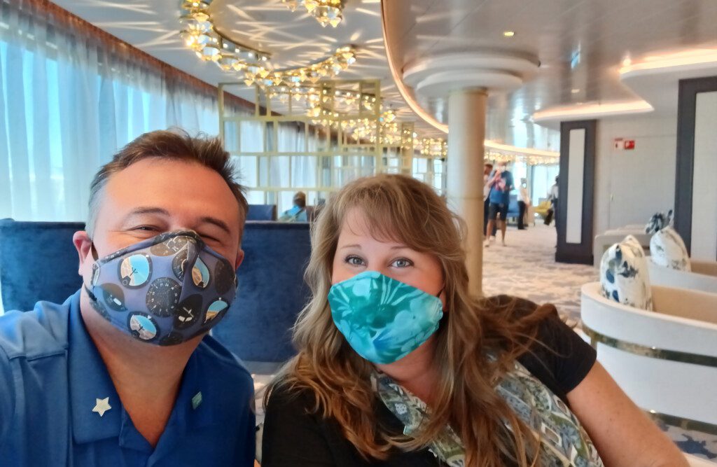 a man and woman wearing masks