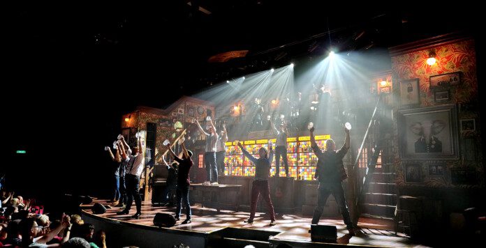 a group of people on a stage with bright lights