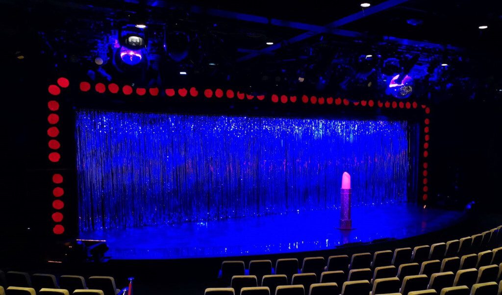 a stage with blue lights and a stage with a red object
