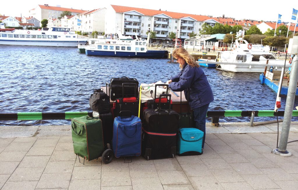 a woman standing next to a pile of luggage