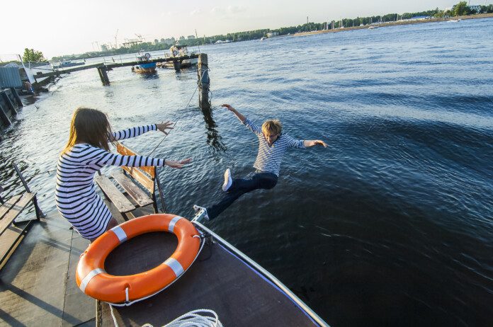 A woman throws her boyfriend off a dock
