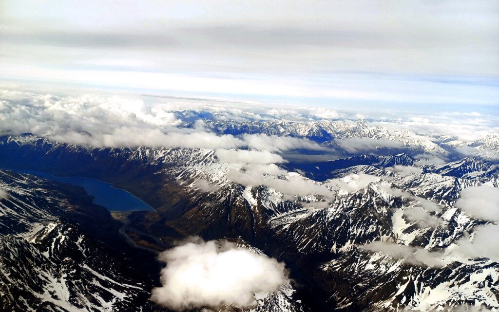 a aerial view of mountains and clouds