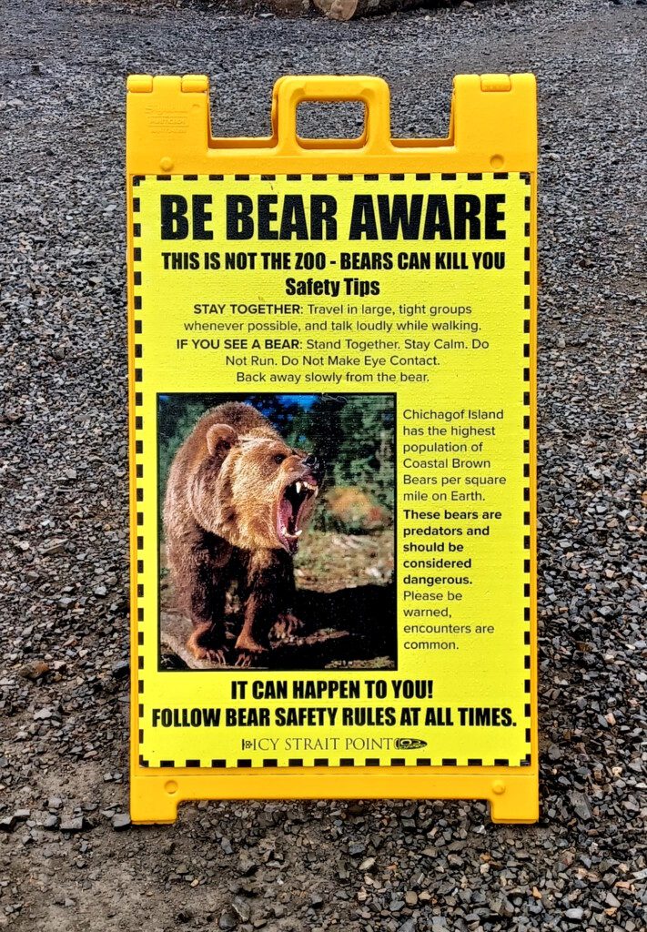 a yellow sign with a bear on it