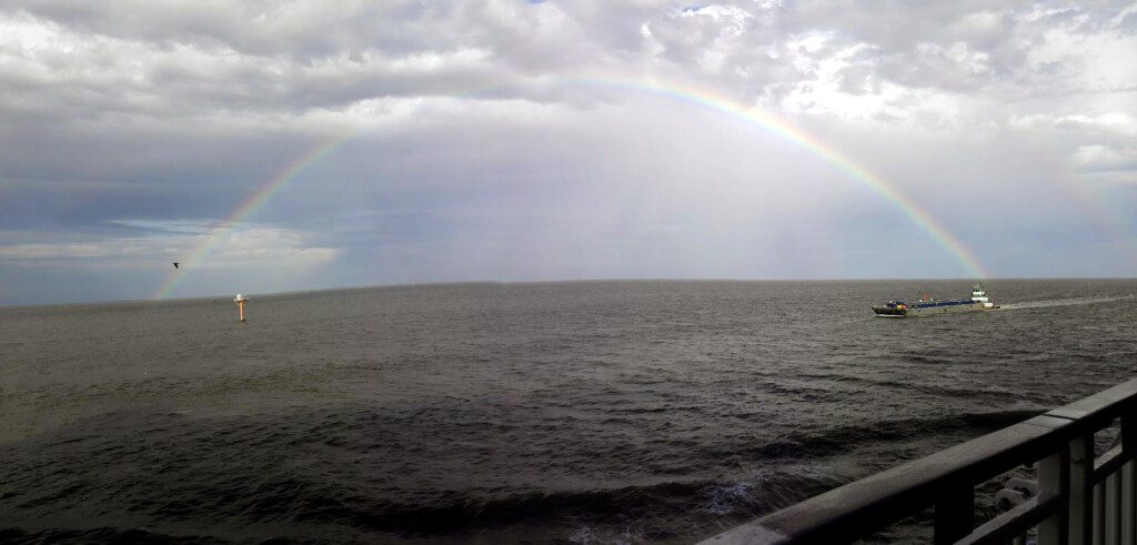 a rainbow over a body of water