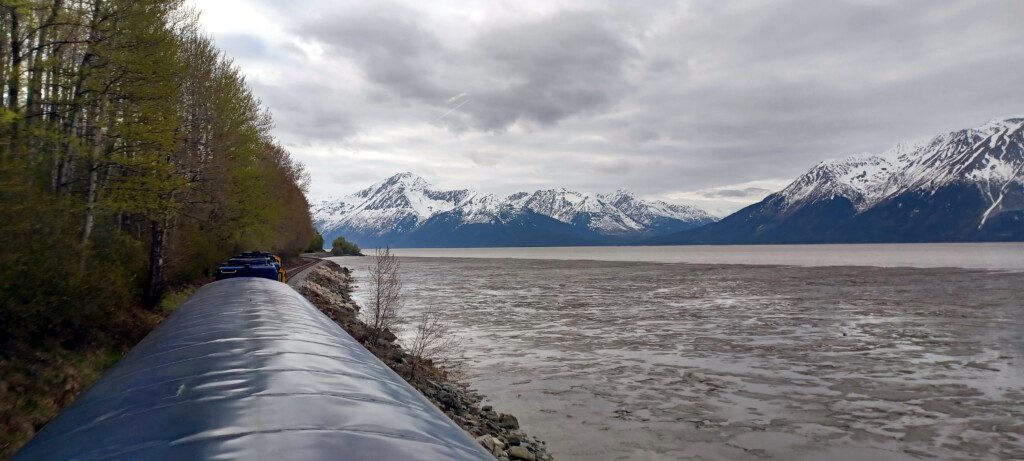 a train tracks next to a body of water