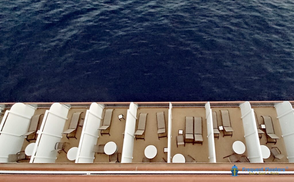 a deck of a cruise ship with chairs and tables