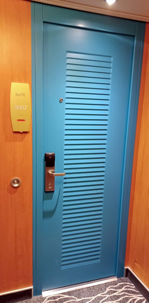 a blue door with a doorknob and a sign