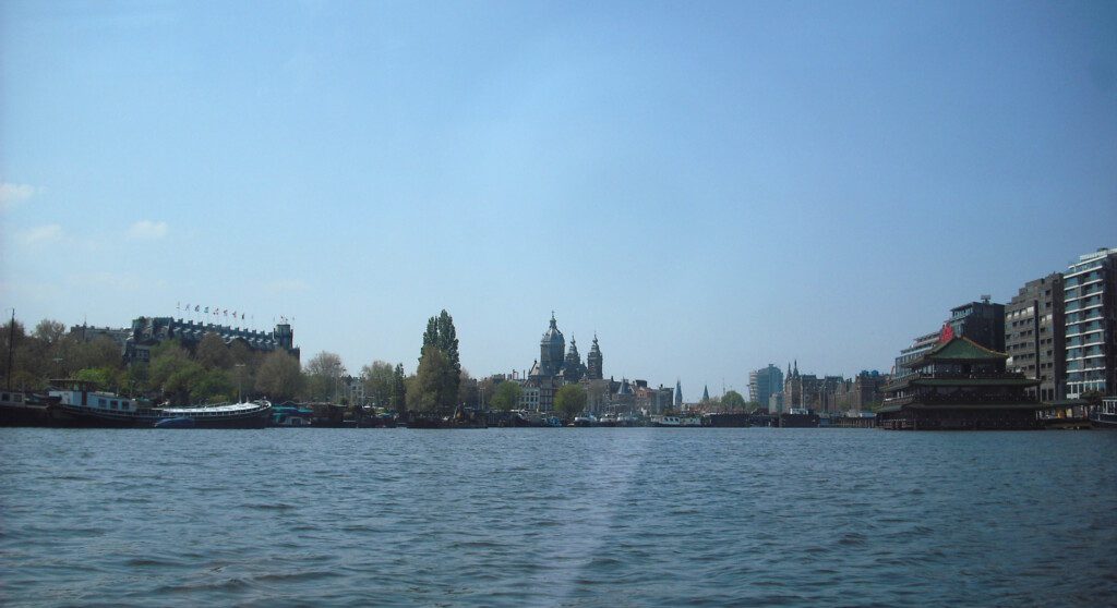 a body of water with buildings in the background