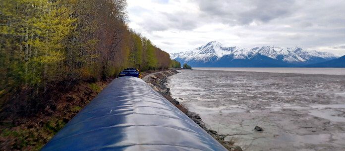 a train going down a train track by a body of water