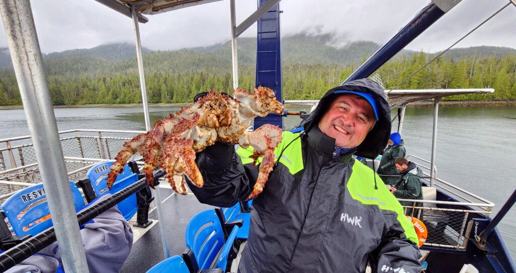 a man holding a crab on a boat