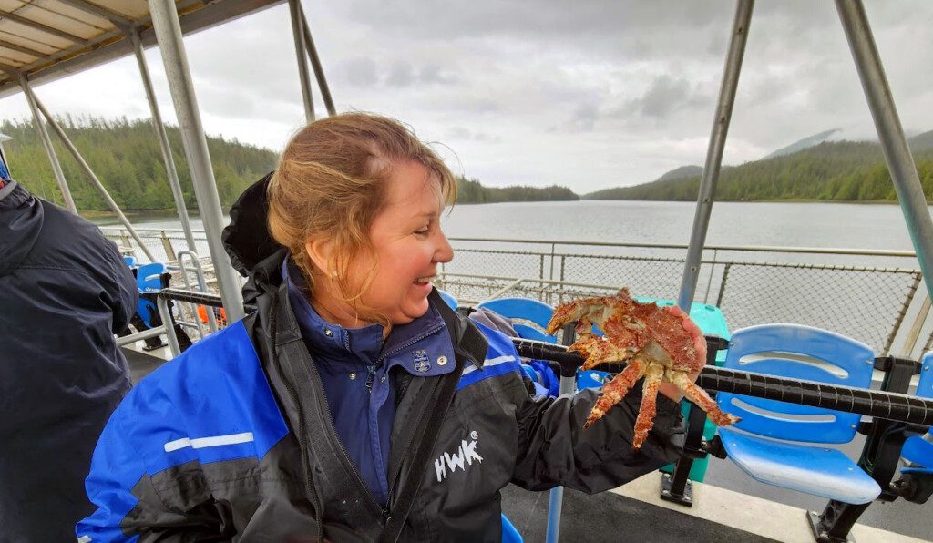 a woman holding a crab