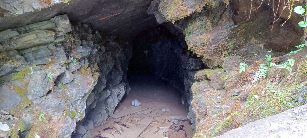 a cave entrance with rocks and dirt