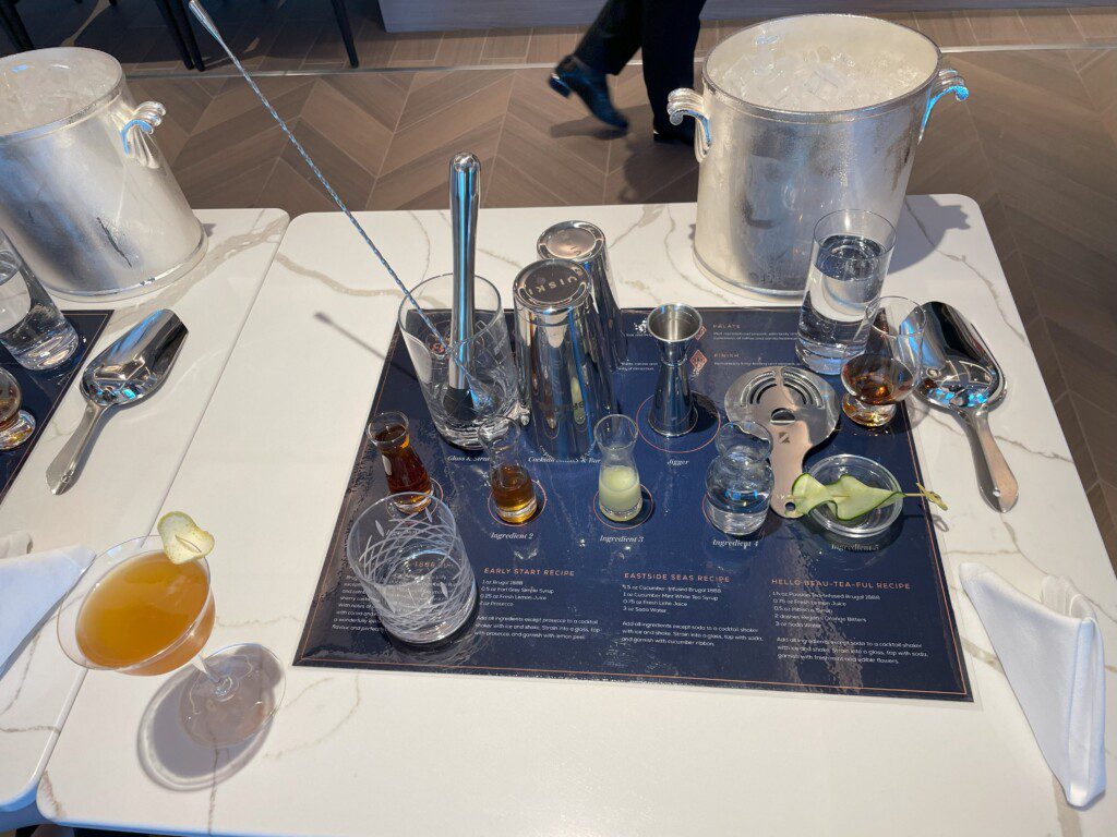 a table with a drink and glasses