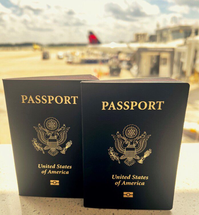 two black passport with gold text on it