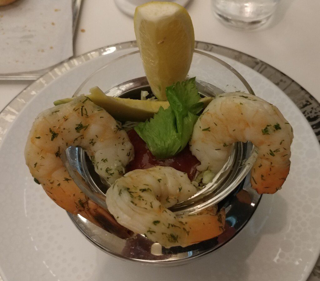 a shrimp cocktail with a lemon wedge
