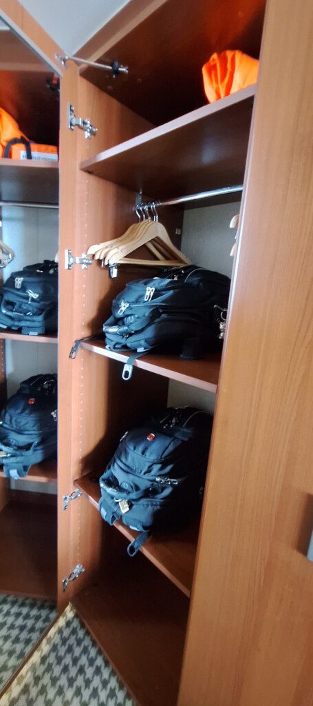 a closet with backpacks and swingers