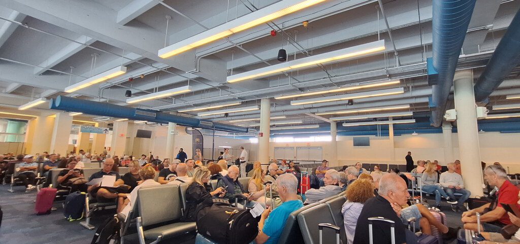a group of people sitting in an airport