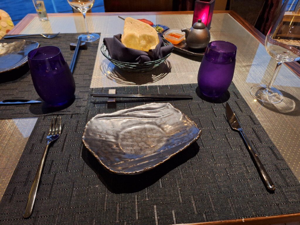 a table with a plate and glasses