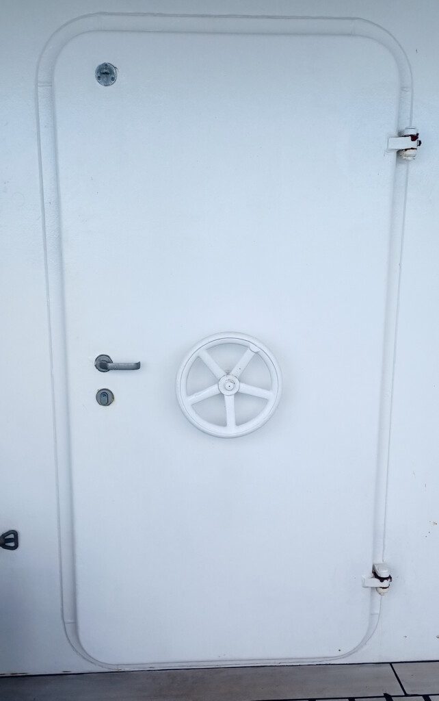 a white door with a wheel on it
