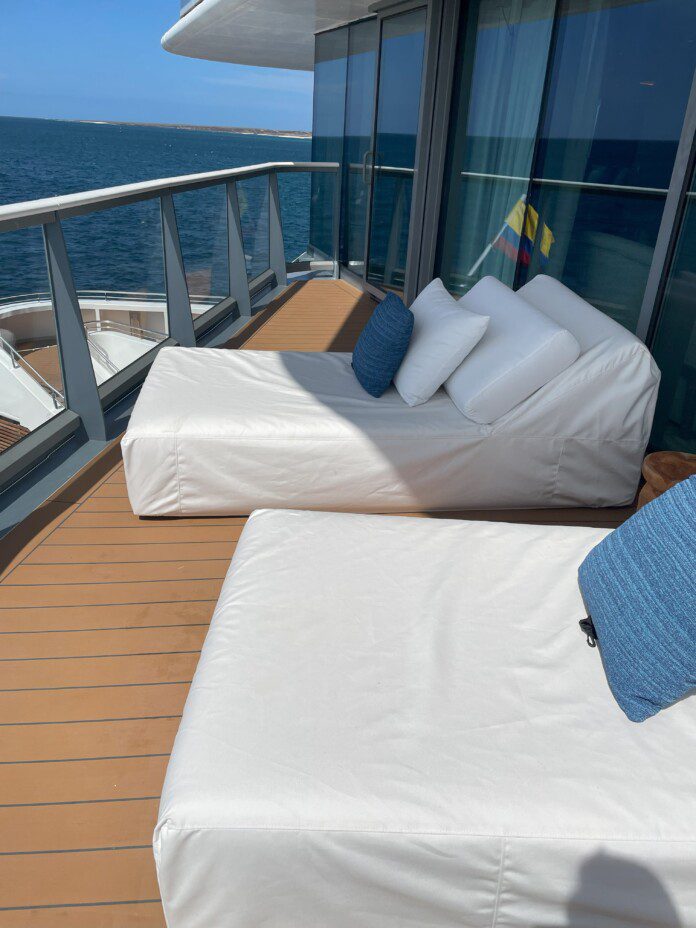 two beds on a deck overlooking the water