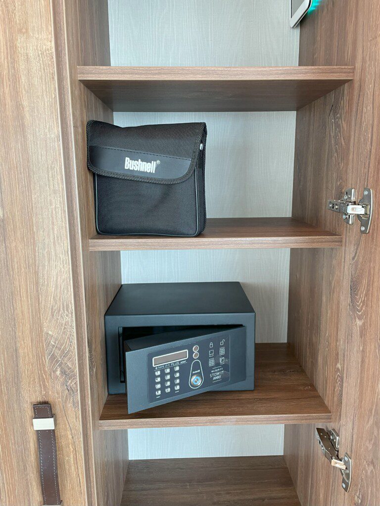 a black box and a black case on a wooden shelf