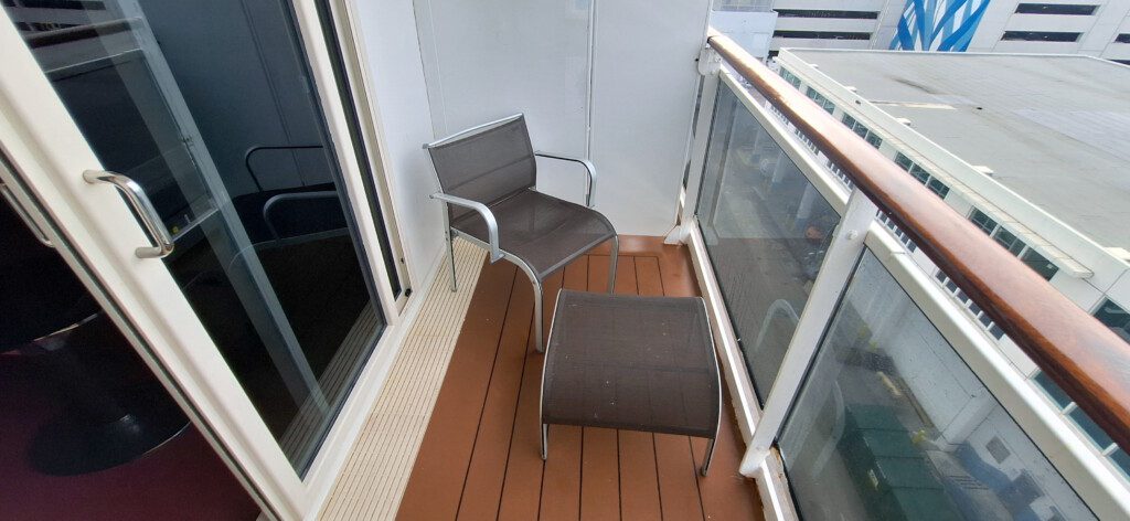 a chair and table on a balcony