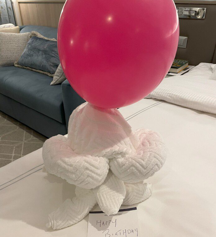 a pink balloon on a white towel