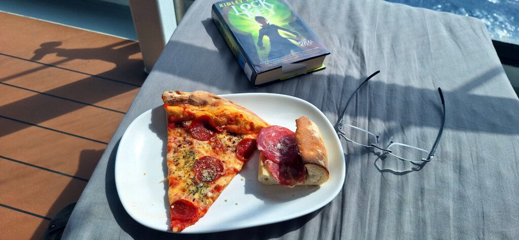a plate of pizza and a book on a table