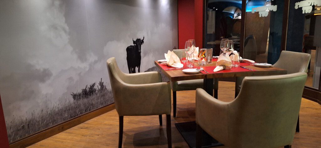 a table with chairs and a painting on the wall