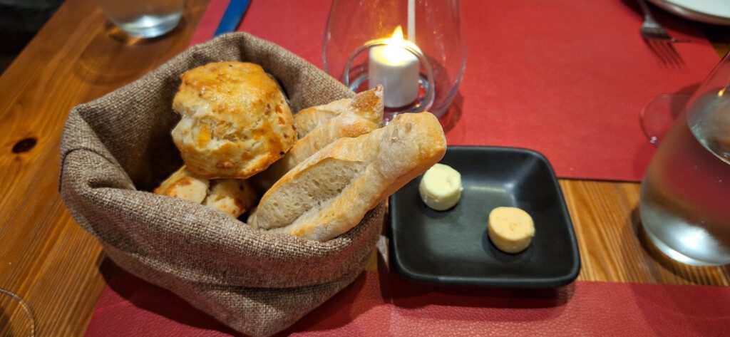 a bag of bread and cheese on a plate