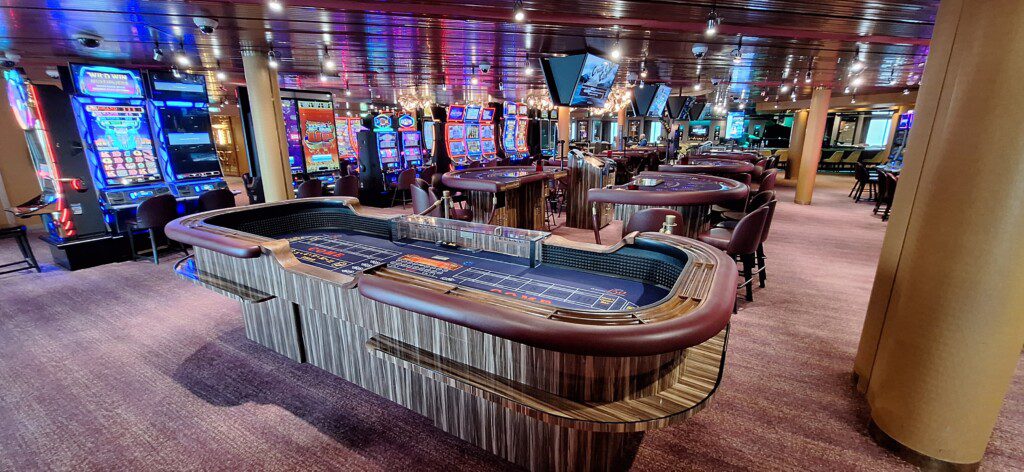 a casino with a table and gaming machines