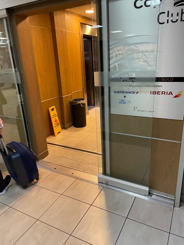a glass door with a sign and a suitcase in it