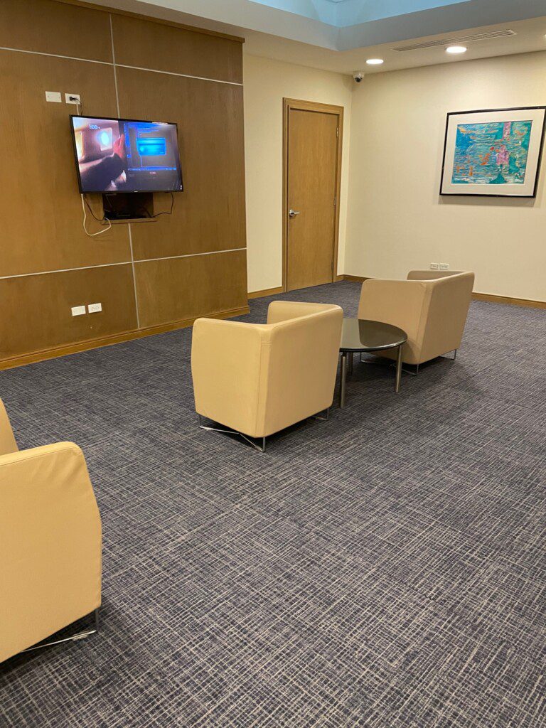 a room with chairs and a television on the wall