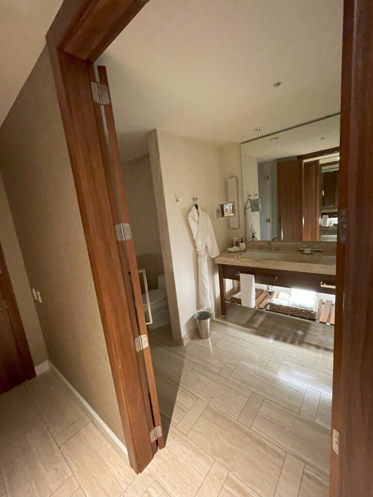 a bathroom with a white robe and a sink