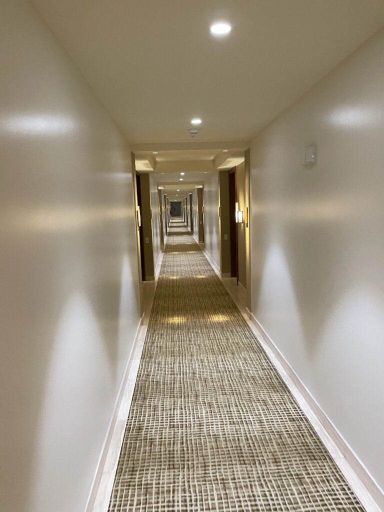 a long hallway with lights on