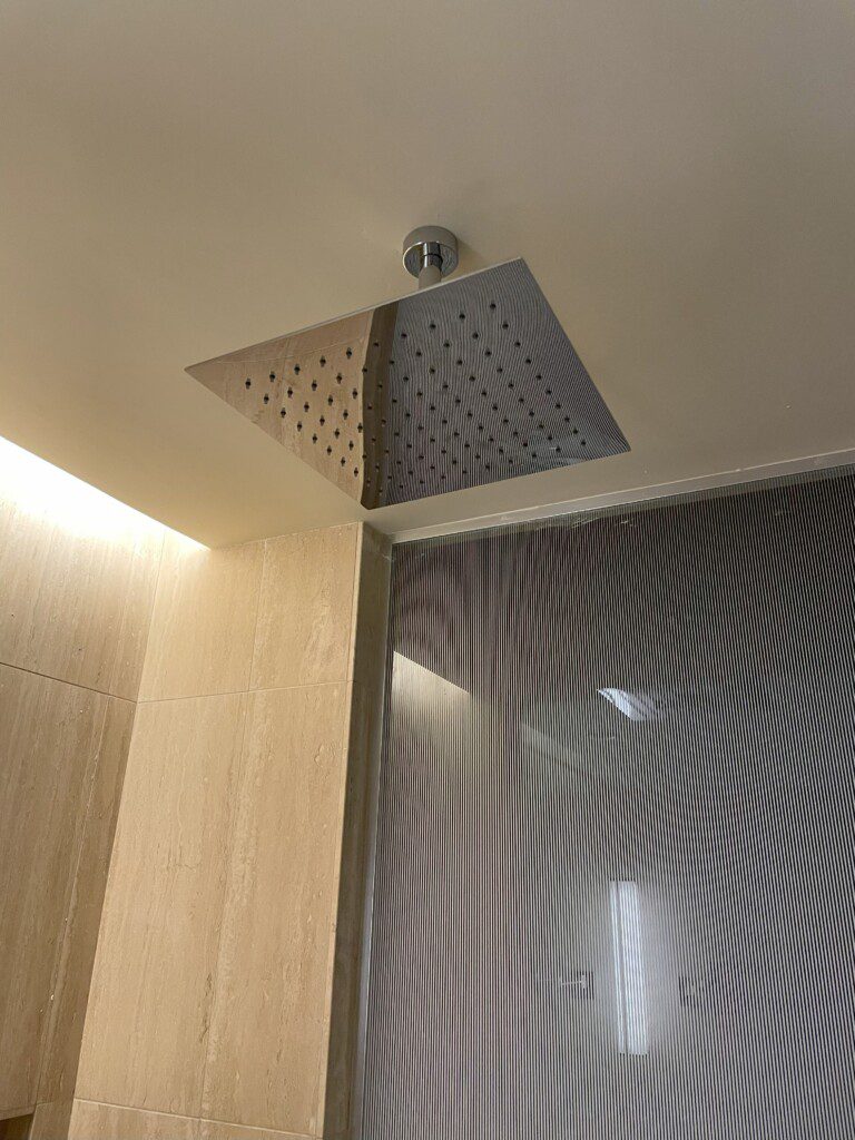 a shower head with a pattern on the wall