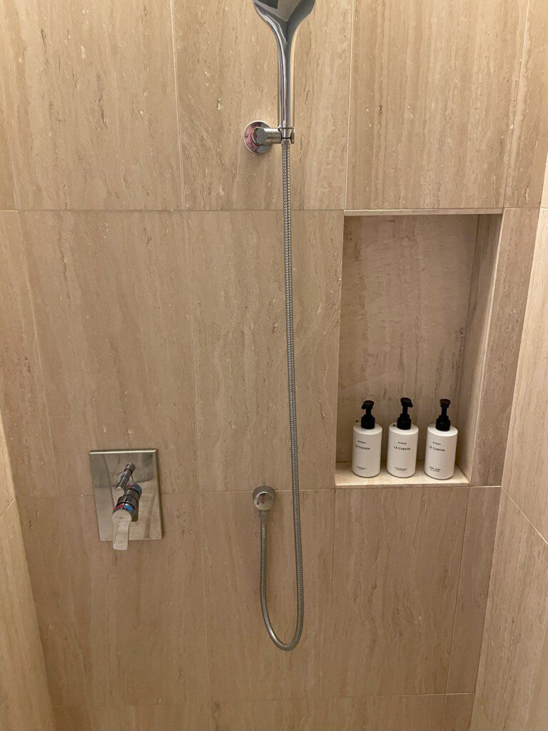 a shower with a shower head and a shower head
