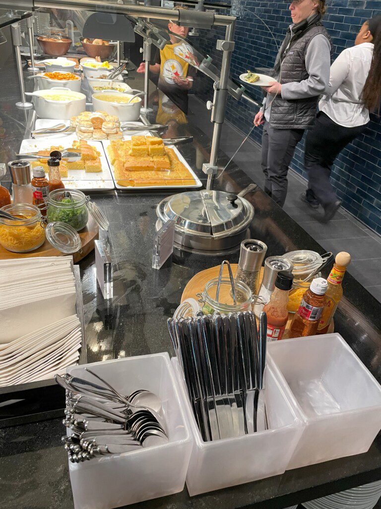 a buffet line with food and utensils