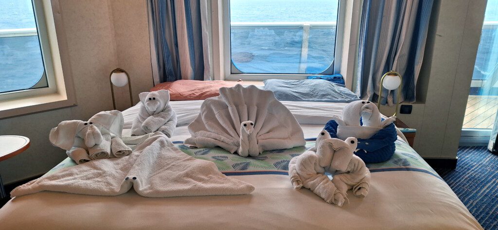 a bed with towels made out of animals